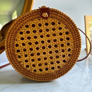 Handwoven Round Rattan Bag with natural leather straps.